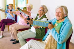 Cheerful senior women exercising their arms.